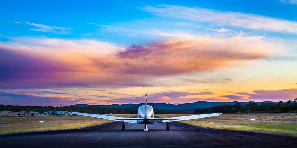 Light aircraft on runway at sunset at Warnervale Airport on the NSW Central Coast