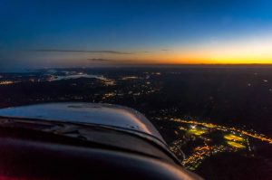 An aircraft flying during sunset.